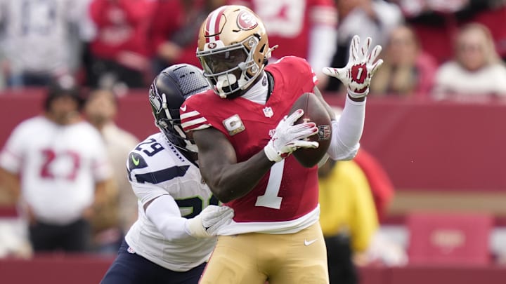 November 17, 2024; Santa Clara, California, USA; San Francisco 49ers wide receiver Deebo Samuel Sr. (1) runs the football against Seattle Seahawks cornerback Josh Jobe (29) during the first quarter at Levi's Stadium. Mandatory Credit: Kyle Terada-Imagn Images