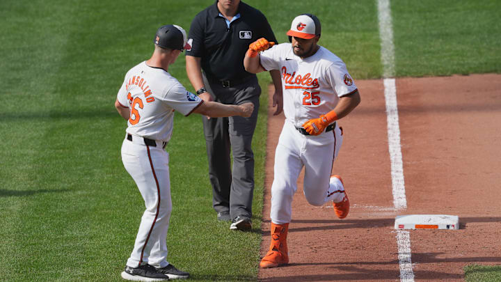 Sep 19, 2024; Baltimore, Maryland, USA; Baltimore Orioles designated hitter Anthony Santander (25) greeted by third base coach Tony Mansolino (36) following his game winning two run home run in the ninth inning against the San Francisco Giants at Oriole Park at Camden Yards.