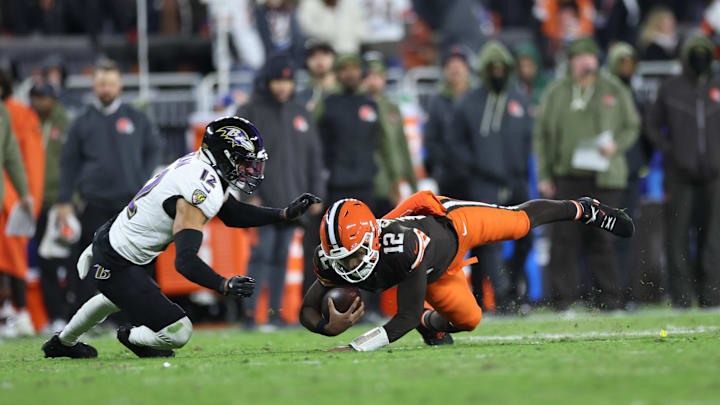 Nov 16, 2025; Cleveland, Ohio, USA; Cleveland Browns quarterback Shedeur Sanders (12) dives for a gain past Baltimore Ravens safety Alohi Gilman (12) during the fourth quarter at Huntington Bank Field. Mandatory Credit: Scott Galvin-Imagn Images