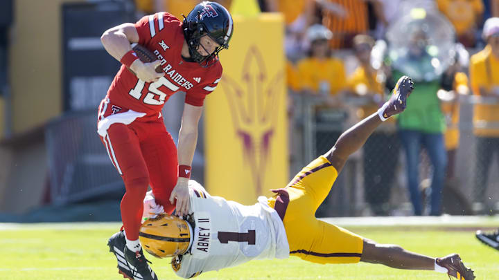 Oct 18, 2025; Tempe, Arizona, USA; Texas Tech Red Raiders quarterback Will Hammond (15) is tackled by Arizona State Sun Devils defensive back Keith Abney II (1) in the first half at Mountain America Stadium. Mandatory Credit: Mark J. Rebilas-Imagn Images Oct 18, 2025; Tempe, Arizona, USA; Texas Tech Red Raiders quarterback Will Hammond (15) is tackled by Arizona State Sun Devils defensive back Keith Abney II (1) in the first half at Mountain America Stadium. Mandatory Credit: Mark J. Rebilas-Imagn Images