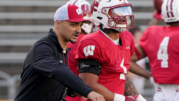 Apr 11, 2023; Madison, WI, USA; Wisconsin running backs coach Devon Spalding talks with running back Chez Mellusi (1) during practice Tuesday, April 11, 2023 at Camp Randall Stadium in Madison, Wis. Mandatory Credit: Mark Hoffman-Imagn Images