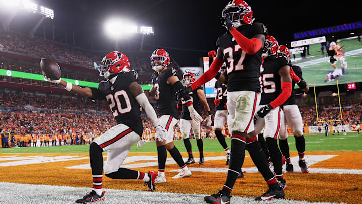 Dec 11, 2025; Tampa, Florida, USA; Atlanta Falcons cornerback Dee Alford (20) celebrates with safety Jessie Bates III (3) and cornerback Cobee Bryant (37) after intercepting a pass intended for Tampa Bay Buccaneers wide receiver Mike Evans (not pictured) during the fourth quarter at Raymond James Stadium. Mandatory Credit: Kim Klement Neitzel-Imagn Images