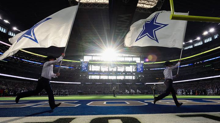 A general view of the field as flag runners run by after a Dallas Cowboys score against the Detroit Lions at AT&T Stadium. A general view of the field as flag runners run by after a Dallas Cowboys score against the Detroit Lions at AT&T Stadium.