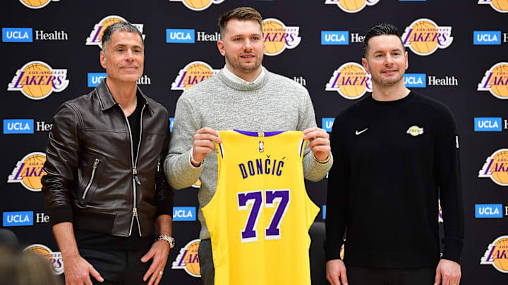 Feb 4, 2025; El Segundo, CA, USA; Los Angeles Lakers guard Luka Doncic poses for photos with general manager Rob Pelinka and head coach JJ Redick at UCLA Health Training Center. Mandatory Credit: Gary A. Vasquez-Imagn Images