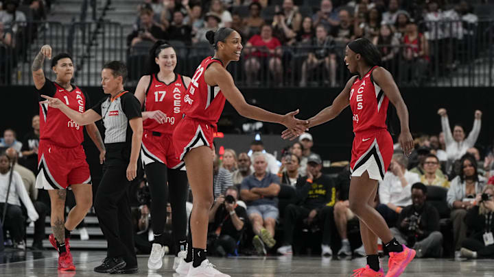 Sep 7, 2025; Las Vegas, Nevada, USA; Las Vegas Aces guard Jackie Young (0) celebrates with centers A'ja Wilson (22), Megan Gustafson (17) and forward Kierstan Bell (1) after scoring against the Chicago Sky during the first half of a WNBA basketball game at T-Mobile Arena. Mandatory Credit: Lucas Peltier-Imagn Images Sep 7, 2025; Las Vegas, Nevada, USA; Las Vegas Aces guard Jackie Young (0) celebrates with centers A'ja Wilson (22), Megan Gustafson (17) and forward Kierstan Bell (1) after scoring against the Chicago Sky during the first half of a WNBA basketball game at T-Mobile Arena. Mandatory Credit: Lucas Peltier-Imagn Images