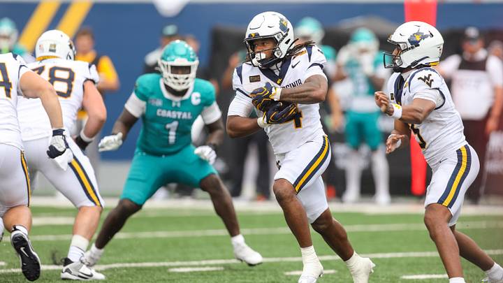 Sep 5, 2026; Morgantown, West Virginia, USA; West Virginia Mountaineers running back Cam Cook (4) runs the ball during the fourth quarter against the Coastal Carolina Chanticleers at Milan Puskar Stadium. Mandatory Credit: Ben Queen-Imagn Images Sep 5, 2026; Morgantown, West Virginia, USA; West Virginia Mountaineers running back Cam Cook (4) runs the ball during the fourth quarter against the Coastal Carolina Chanticleers at Milan Puskar Stadium. Mandatory Credit: Ben Queen-Imagn Images