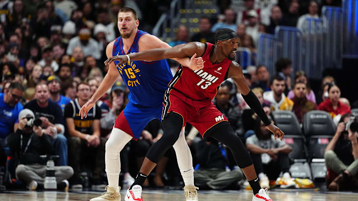 Nov 8, 2024; Denver, Colorado, USA; Miami Heat center Bam Adebayo (13) and Denver Nuggets center Nikola Jokic (15) battle for position on the court in the second half at Ball Arena. Mandatory Credit: Ron Chenoy-Imagn Images