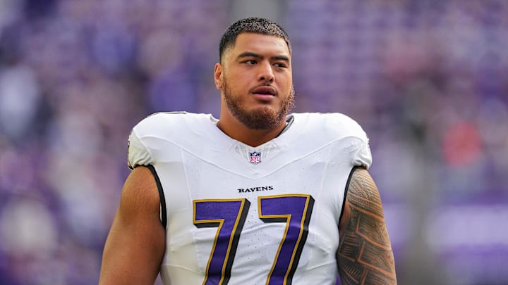 Nov 9, 2025; Minneapolis, Minnesota, USA; Baltimore Ravens guard Daniel Faalele (77) warms up before the game against the Minnesota Vikings at U.S. Bank Stadium. Mandatory Credit: Brad Rempel-Imagn Images