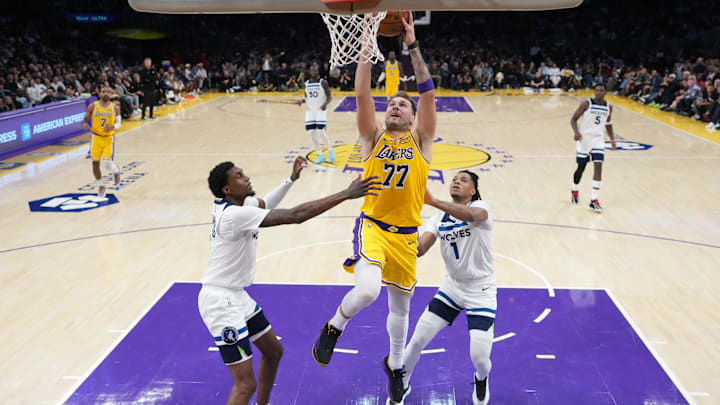 Oct 24, 2025; Los Angeles, California, USA; Los Angeles Lakers guard Luka Doncic (77) shoots the ball against Minnesota Timberwolves guard Terrence Shannon Jr. (1) and forward Jaden McDaniels (3) in the second half at Crypto.com Arena. Mandatory Credit: Kirby Lee-Imagn Images Oct 24, 2025; Los Angeles, California, USA; Los Angeles Lakers guard Luka Doncic (77) shoots the ball against Minnesota Timberwolves guard Terrence Shannon Jr. (1) and forward Jaden McDaniels (3) in the second half at Crypto.com Arena. Mandatory Credit: Kirby Lee-Imagn Images