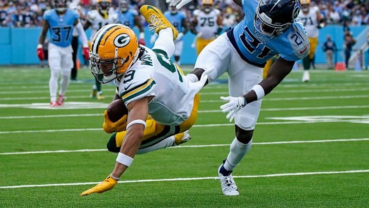 Green Bay Packers wide receiver Christian Watson (9) receives a pass past Tennessee Titans cornerback Roger McCreary (21) during the first quarter at Nissan Stadium in Nashville, Tenn., Sunday, Sept. 22, 2024.
