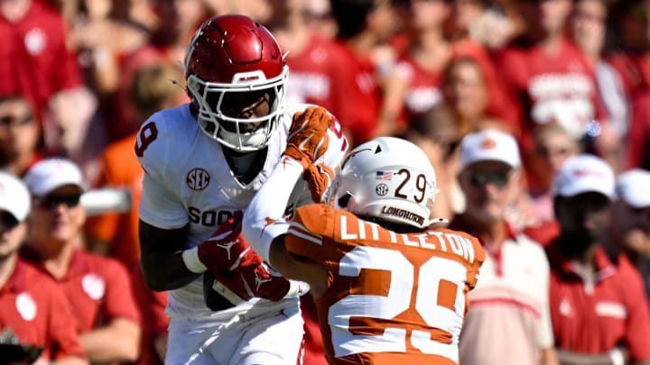 Oct 11, 2025; Dallas, Texas, USA; Oklahoma Sooners wide receiver Keontez Lewis (9) catches a pass in front of Texas Longhorns defensive back Graceson Littleton (29) during the game between the Texas Longhorns and the Oklahoma Sooners at the Cotton Bowl. Mandatory Credit: Jerome Miron-Imagn Images