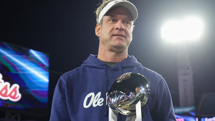Mississippi Rebels head coach Lane Kiffin is givent the Gator Bowl trophy after beating the Duke Blue Devils at EverBank Stadium. Mississippi Rebels head coach Lane Kiffin is givent the Gator Bowl trophy after beating the Duke Blue Devils at EverBank Stadium.