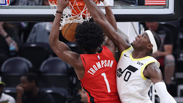 Oct 7, 2024; Salt Lake City, Utah, USA; Houston Rockets forward Amen Thompson (1) dunks the ball against Utah Jazz forward Taylor Hendricks (0) during the first quarter at Delta Center. Mandatory Credit: Rob Gray-Imagn Images