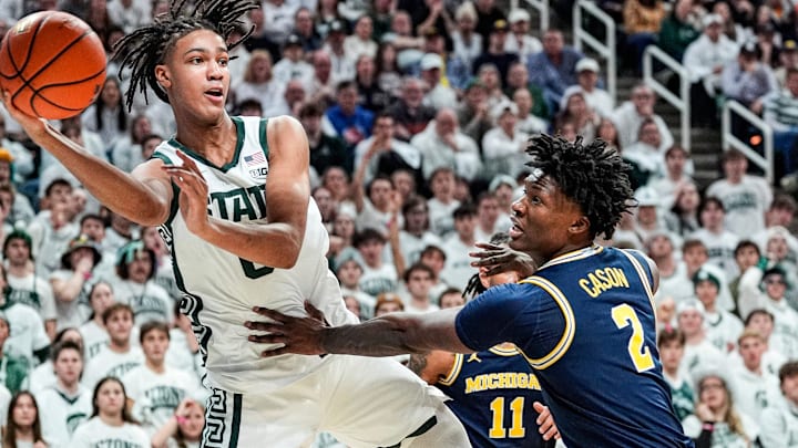 Michigan State forward Jordan Scott (6) saves an out of bound ball against Michigan guard L.J. Cason (2) during the first half at Breslin Center in East Lansing on Friday, Jan. 30, 2026.