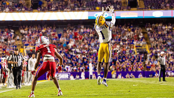 Sep 6, 2025; Baton Rouge, Louisiana, USA;  LSU Tigers cornerback Ashton Stamps (1) misses an interception intended for Louisiana Tech Bulldogs wide receiver Devin Gandy (1) during the second half at Tiger Stadium. Mandatory Credit: Stephen Lew-Imagn Images