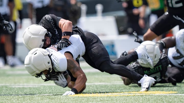 Combat Ducks inside linebacker Brayden Platt brings down Fighting Ducks running back Makhi Hughes as the Fighting Ducks face off against Mighty Oregon in the Oregon Ducks spring game on April 26, 2025, at Autzen Stadium in Eugene.