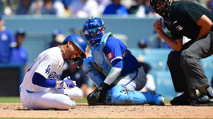 Jun 16, 2024; Los Angeles, California, USA; Los Angeles Dodgers shortstop Mookie Betts (50) reacts after being hit by pitch from Kansas City Royals pitcher Dan Altavilla (54) during the seventh inning at Dodger Stadium. Mandatory Credit: Gary A. Vasquez-USA TODAY Sports