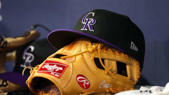 Jun 15, 2023; Atlanta, Georgia, USA; A detailed view of a Colorado Rockies hat and glove on the bench against the Atlanta Braves in the ninth inning at Truist Park. Mandatory Credit: Brett Davis-Imagn Images