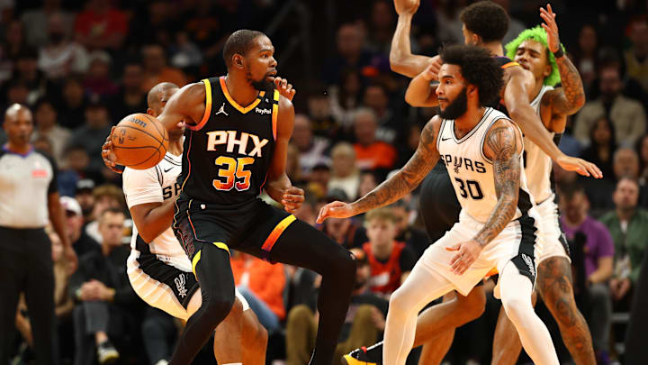 Dec 3, 2024; Phoenix, Arizona, USA; Phoenix Suns forward Kevin Durant (35) against San Antonio Spurs forward Julian Champagnie (30) in the first half of an NBA Cup game at Footprint Center. Mandatory Credit: Mark J. Rebilas-Imagn Images