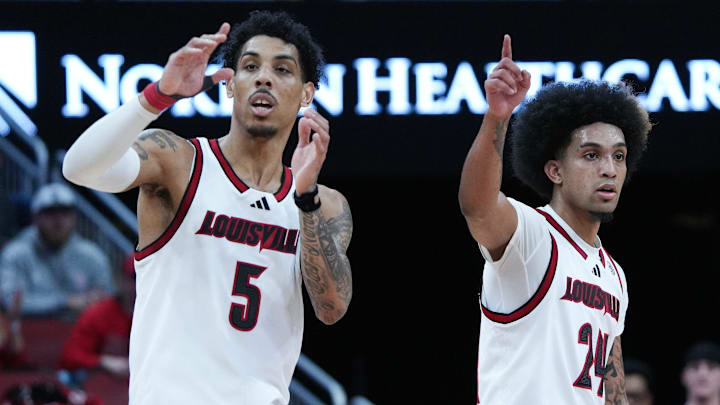 Louisville guard Terrence Edwards Jr. (5) and guard Chucky Hepburn (24) watch a teammate shoot free throws against California during their game at the KFC Yum! Center in Louisville, Ky. on Mar. 5, 2025.