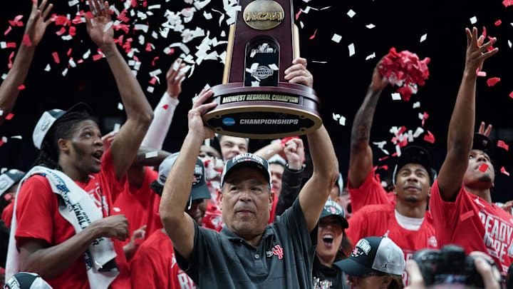 Houston Cougars head coach Kelvin Sampson holds the trophy for winning the Midwest Regional final.
