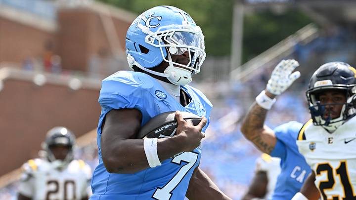 Sep 12, 2026; Chapel Hill, North Carolina, USA; North Carolina Tar Heels running back Benjamin Hall (7)scores a touchdown as ETSU Buccaneers defensive back Tamajh Mitchell (21) defends in the second quarter at Kenan Stadium. Mandatory Credit: Bob Donnan-Imagn Images Sep 12, 2026; Chapel Hill, North Carolina, USA; North Carolina Tar Heels running back Benjamin Hall (7)scores a touchdown as ETSU Buccaneers defensive back Tamajh Mitchell (21) defends in the second quarter at Kenan Stadium. Mandatory Credit: Bob Donnan-Imagn Images