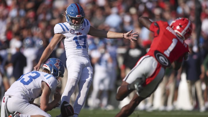 Oct 18, 2025; Athens, Georgia, USA;  Mississippi Rebels kicker Lucas Carneiro (17) kicks the extra point against Georgia Bulldogs defensive back Ellis Robinson IV (1) during the first quarter of the game at Sanford Stadium. Mandatory Credit: Brett Davis-Imagn Images