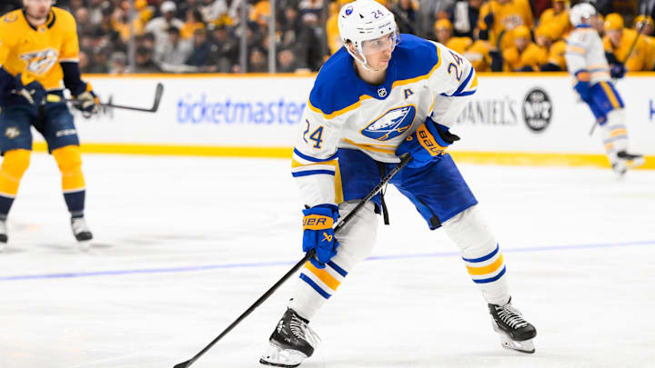 Feb 8, 2025; Nashville, Tennessee, USA;  Buffalo Sabres center Dylan Cozens (24) takes a shot on goal during the second period at Bridgestone Arena. Mandatory Credit: Steve Roberts-Imagn Images