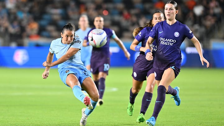 Aug 23, 2024; Houston, Texas, USA; Houston Dash midfielder Barbara Olivieri (15) shoots the ball against Orlando Pride midfielder Haley McCutcheon (2) in the second half at Shell Energy Stadium. Mandatory Credit: Maria Lysaker-USA TODAY Sports