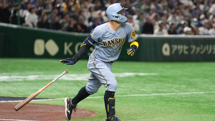 Mar 16, 2025; Bunkyo, Tokyo, Japan; Hanshin Tigers third baseman Teruaki Sato (8) runs to first base after hitting a home run against the Los Angeles Dodgers during the fourth inning at Tokyo Dome. Mandatory Credit: Darren Yamashita-Imagn Images