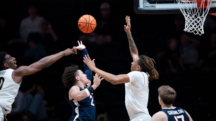 Virginia guard Chance Mallory (2) between Vanderbilt forward Tyler Harris (8) and forward AK Okereke (10) during the second half of their exhibition game at Memorial Gym in Nashville, Tenn., Thursday, Oct. 16, 2025.