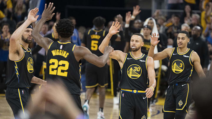 May 18, 2022; San Francisco, California, USA; Golden State Warriors forward Andrew Wiggins (22) is congratulated by guard Klay Thompson (11), guard Stephen Curry (30), and guard Jordan Poole (3) after making a basket against the Dallas Mavericks during the second quarter in game one of the 2022 western conference finals at Chase Center. Mandatory Credit: Kyle Terada-Imagn Images