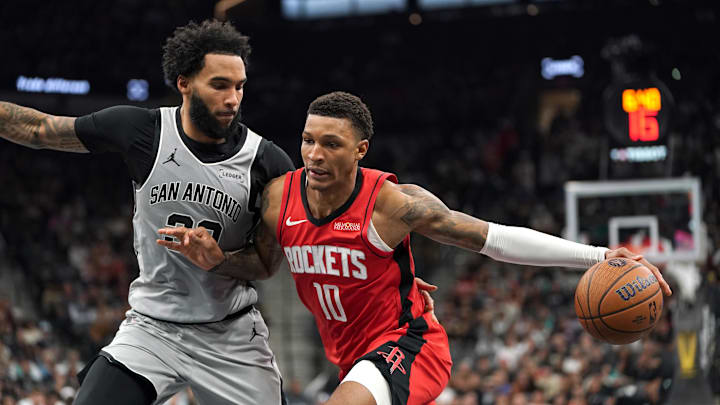 Nov 7, 2025; San Antonio, Texas, USA;  Houston Rockets forward Jabari Smith Jr (10) dribbles against San Antonio Spurs forward Julian Champagnie (30) during the second quarter at Frost Bank Center. Mandatory Credit: Dustin Safranek-Imagn Images