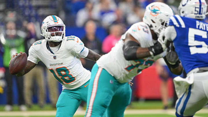 Miami Dolphins quarterback Tyler Huntley (18) scrambles to avoid a sack during the first quarter against the Indianapolis Colts at Lucas Oil Stadium.