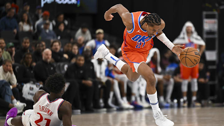 Nov 2, 2024; Inglewood, California, USA; Oklahoma City Thunder guard Aaron Wiggins (21) drives the ball against LA Clippers guard Kobe Brown (21) during the second half at Intuit Dome. Mandatory Credit: Jonathan Hui-Imagn Images