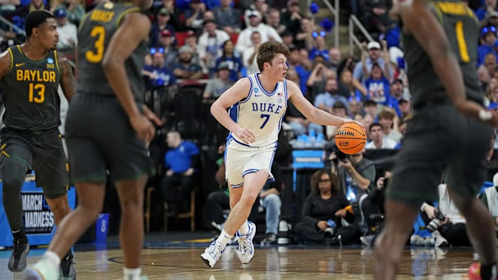 Mar 23, 2025; Raleigh, NC, USA; Duke Blue Devils guard Kon Knueppel (7) drives to the basket as Baylor Bears guard Jeremy Roach (3) and Baylor Bears guard Robert Wright III (1) defend during the first half in the second round of the NCAA Tournament at Lenovo Center. Mandatory Credit: Bob Donnan-Imagn Images