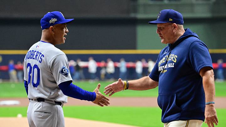 Oct 13, 2025; Milwaukee, Wisconsin, USA; Los Angeles Dodgers manager Dave Roberts (30) greets Milwaukee Brewers manager Pat Murphy (49) prior to game one of the NLCS round for the 2025 MLB playoffs at American Family Field. Mandatory Credit: Benny Sieu-Imagn Images