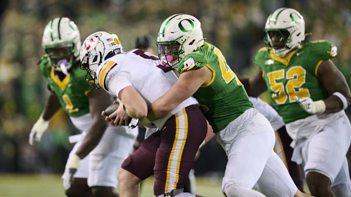 Nov 14, 2025; Eugene, Oregon, USA; Oregon Ducks linebacker Teitum Tuioti (44) sacks Minnesota Golden Gophers quarterback Drake Lindsey (5) during the second half at Autzen Stadium. Mandatory Credit: Troy Wayrynen-Imagn Images