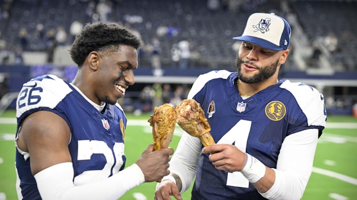 Dallas Cowboys cornerback DaRon Bland and Dak Prescott eat turkey legs after the Cowboys victory over the Washington Commanders 