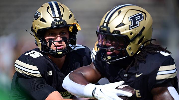 Purdue Boilermakers quarterback Ryan Browne (15) hands the ball off to running back Fame Ijeboi (2). Purdue Boilermakers quarterback Ryan Browne (15) hands the ball off to running back Fame Ijeboi (2).