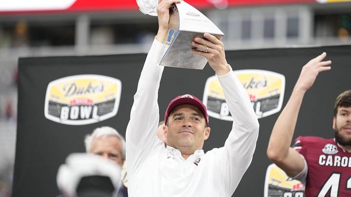 Dec 30, 2021; Charlotte, NC, USA;  South Carolina Gamecocks head coach Shane Beamer celebrates his first bowl win with the South Carolina Gamecocks over the North Carolina Tar Heels at Bank of America Stadium. Mandatory Credit: Jim Dedmon-Imagn Images