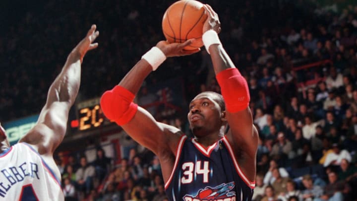 November 30, 1996; Landover, MD; FILE PHOTO: Houston center Hakeem Olajuwon (#34) shoots a jumper over Washington's Chris Webber (#4), at the USAir Arena. Mandatory Credit: Porter Binks-USA TODAY Network 
