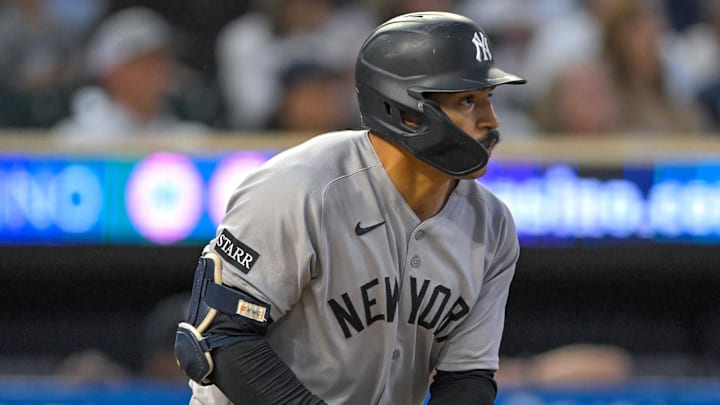 Sep 17, 2025; Minneapolis, Minnesota, USA;  New York Yankees outfielder Trent Grisham (12) hits a solo home run against the Minnesota Twins during the third inning at Target Field. Mandatory Credit: Nick Wosika-Imagn Images