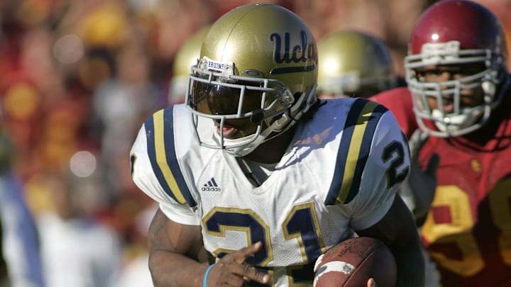 Dec 3, 2005; Los Angeles, CA, USA; FILE PHOTO; UCLA Bruins running back Maurice Jones-Drew (21) carries the ball against the Southern California Trojans at the Los Angeles Memorial Coliseum. Mandatory Credit: Peter Brouillet-Imagn Images
