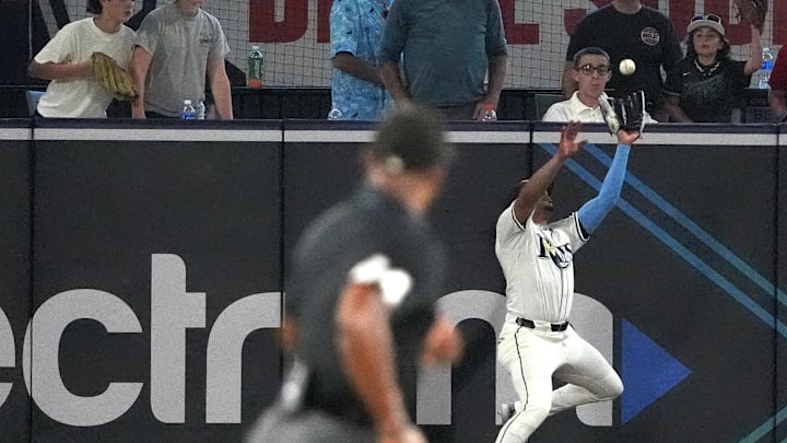 Sep 21, 2025; Tampa, Florida, USA; Fans react as Tampa Bay Rays outfielder Christopher Morel (24) catches a near home run hit by Boston Red Sox outfielder Ceddanne Rafaela (3) during the sixth inning at George M. Steinbrenner Field. Sep 21, 2025; Tampa, Florida, USA; Fans react as Tampa Bay Rays outfielder Christopher Morel (24) catches a near home run hit by Boston Red Sox outfielder Ceddanne Rafaela (3) during the sixth inning at George M. Steinbrenner Field.