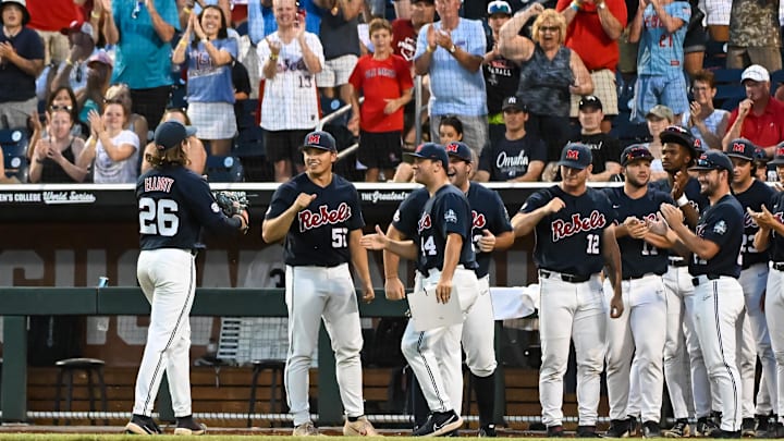 Jun 20, 2022; Omaha, NE, USA;  Ole Miss Rebels pitcher Hunter Elliott (26) greets teammates after being taken out against the Arkansas Razorbacks in the seventh inning at Charles Schwab Field. Mandatory Credit: Steven Branscombe-Imagn Images