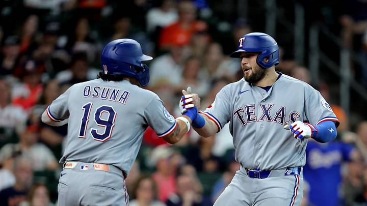 Texas Rangers first baseman Jake Burger (21) is congratulated by left fielder Alejandro Osuna (19).