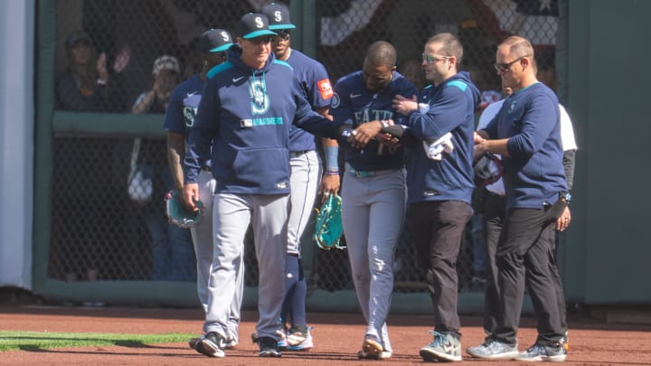 Seattle Mariners right fielder Victor Robles (center) is helped up after dislocating his shoulder against the San Francisco Giants on April 6 at Oracle Park. Seattle Mariners right fielder Victor Robles (center) is helped up after dislocating his shoulder against the San Francisco Giants on April 6 at Oracle Park.