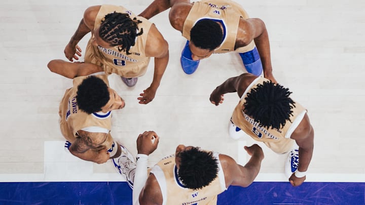 The Huskies gather before plays resumes at Alaska Airlines Arena.