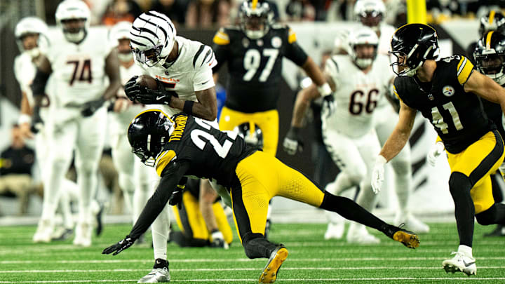 Pittsburgh Steelers safety Juan Thornhill (22) tackles Cincinnati Bengals wide receiver Tee Higgins (5) in the first quarter of the NFL game between the Cincinnati Bengals and Pittsburgh Steelers at Paycor Stadium in Cincinnati on Oct. 16, 2025.
